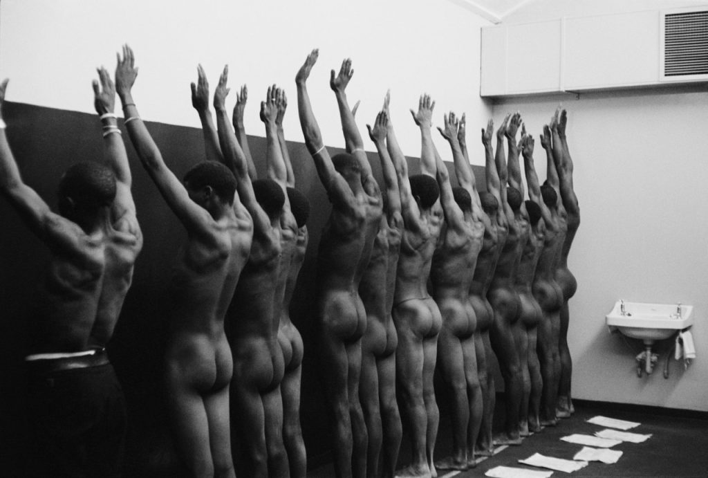 SOUTH AFRICA. 1960s. During group medical examination, the nude men are herded through a string of doctors’ offices.